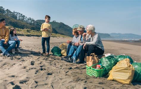 Volunteers Resting after Cleaning the Beach Stock Image - Image of person, outdoors: 148276749