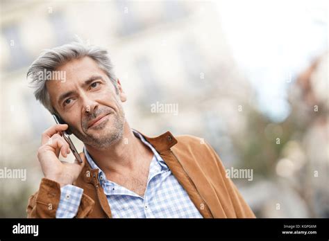 Mature Handsome Man In The Street Talking On Phone Stock Photo Alamy