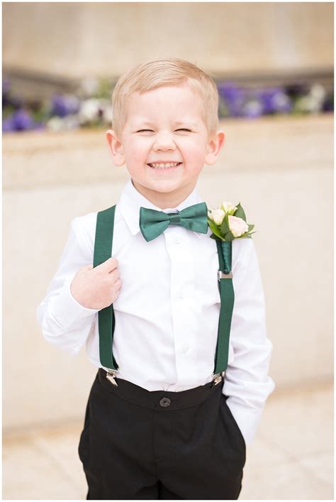 Ring Bearer Cheesy Smile At The Camera With Emerald Green Suspenders