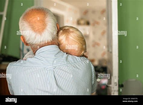 Gray Haired Grandfather With A Blond Haired Girl In Arms Grandfathers And Granddaughters Head