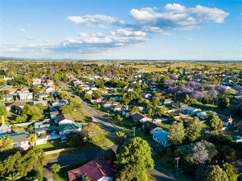 Image of Sunlit quiet suburban street in country town - Austockphoto
