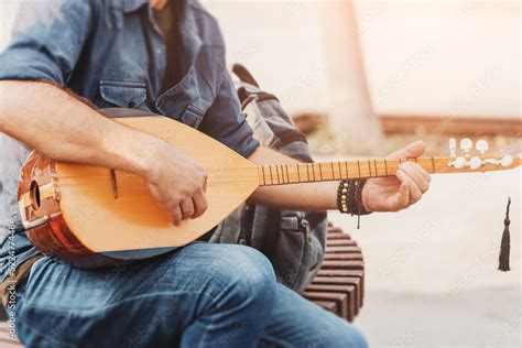 Street Musician Performing Folk Song And Playing On A Traditional