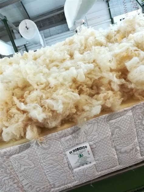 A Pile Of Wool Sitting On Top Of A Bed Frame In A Warehouse Or Building