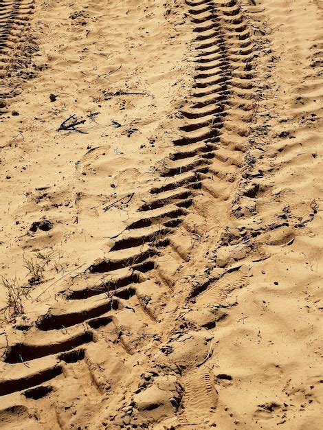 Premium Photo High Angle View Of Tire Tracks On Sand