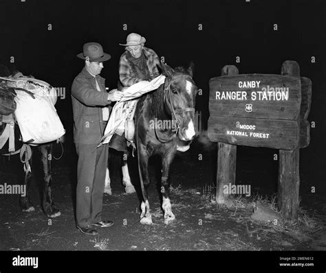 Mesannie Wilkins, hardy Maine woman, gets directions from District Ranger Robert S. Hays at ...