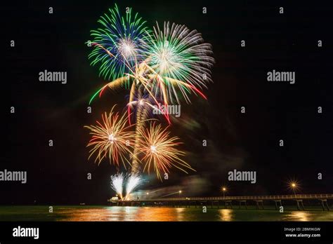 Colourful New Years Fireworks Display Lighting Up The Sky And Water Off