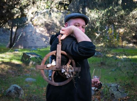 Premium Photo Portrait Of Mature Man Holding Rusty Machinery On Field