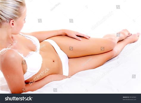 Beautiful Slim Legs And Perfect Woman Body Lying On The White Bed Stock