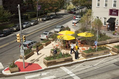 An Aerial View Of People Walking On The Sidewalk In Front Of A