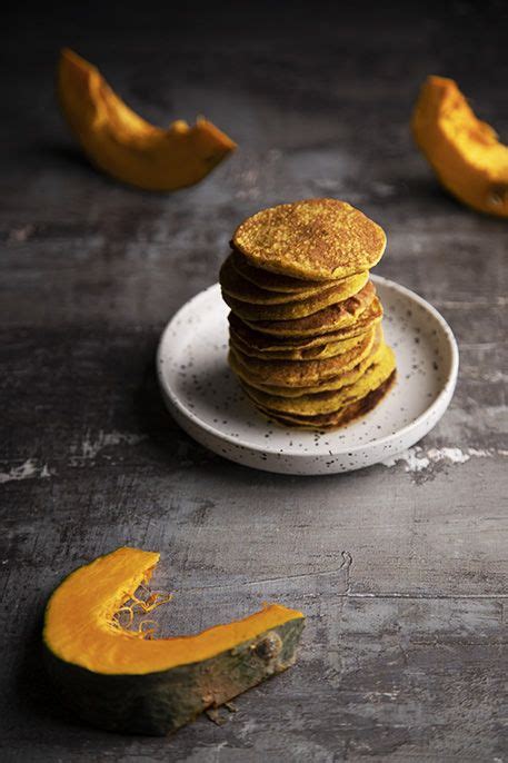 A Stack Of Pancakes Sitting On Top Of A White Plate Next To Slices Of