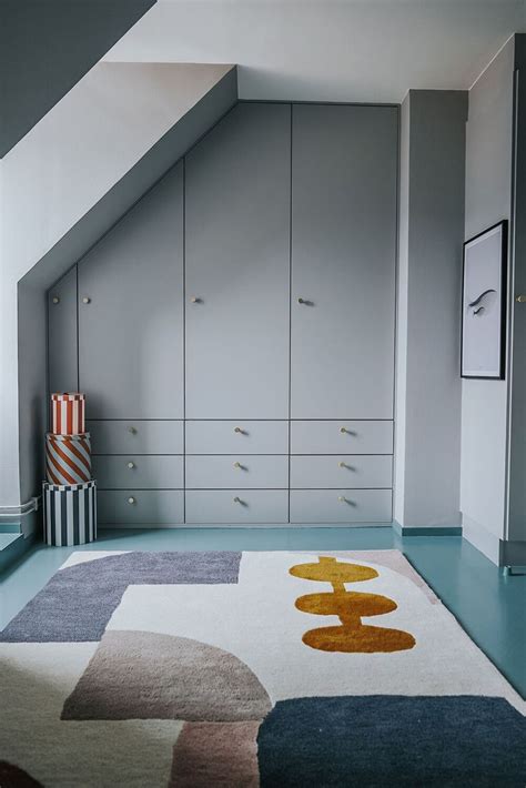 An Image Of A Bedroom Setting With Blue Flooring And White Furniture In