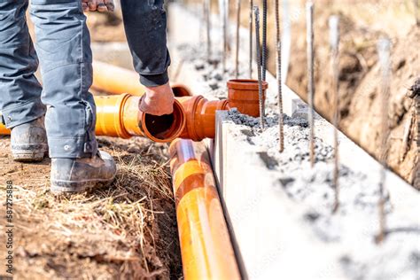 installation of a sewage plastic pipe during the construction of a ...