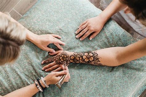 Artist Applying Henna Tattoo On Women Hands Mehndi Is Traditional