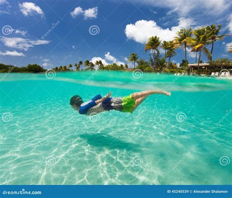 Little Boy Swimming in Ocean Stock Image - Image of active, splash: 45240539