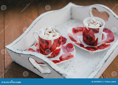 Two Cups Of Hot Cocoa With Marshmallows And Cinnamon On Wooden