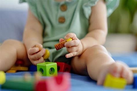 Premium Photo | Baby playing with wooden blocks