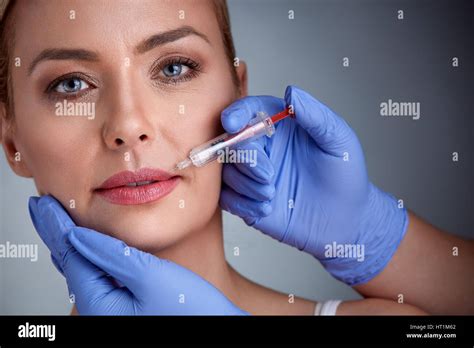 Woman Having Injection Of Botox In Lips Beauty Treatment Stock Photo