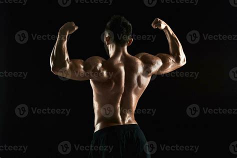 Very Muscular Man Posing With Naked Torso In Studio Stock