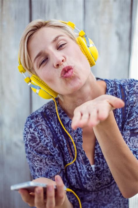 Pretty Blonde Woman Listening Music Her Mobile Phone Blowing Kiss Stock
