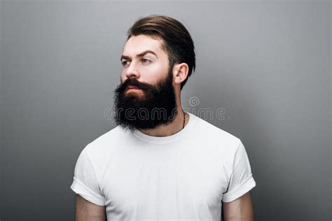 Brutal Hipster Caucasian Male With Thick Beard And Mustache Dressed In