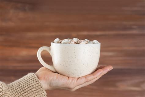 Premium Photo Hot Chocolate With Marshmallows In A Mug In Hand