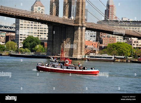 New York City Fireboat passing under the Brooklyn Bridge Brooklyn ...