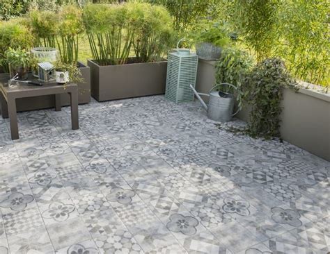 An Outdoor Patio With Potted Plants And Benches