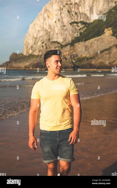 Young Caucasian Man Walking At The Beach Stock Photo Alamy