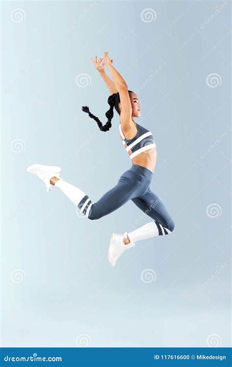 Attractive Excited Fitness Girl Dancer In Sportwear Jumping Of Joy