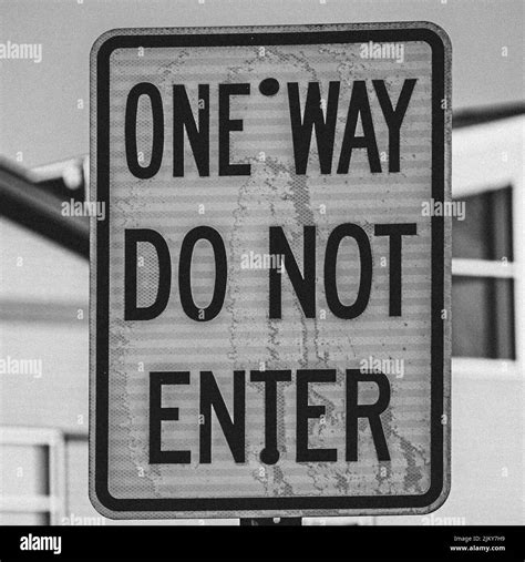 A Grayscale Shot Of Sign With The Text One Way Do Not Enter Stock