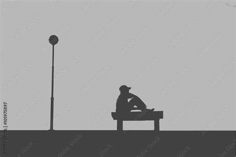 The silhouette of man sitting alone with grey sky, concept of lonely ...