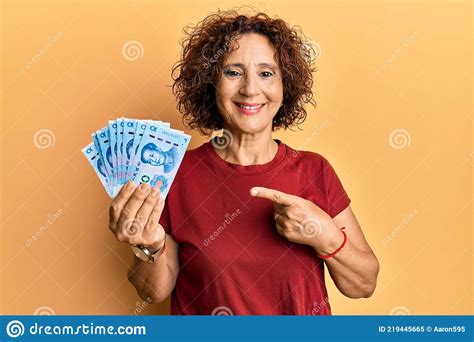 Beautiful Middle Age Mature Woman Holding Yuan Chinese Banknotes