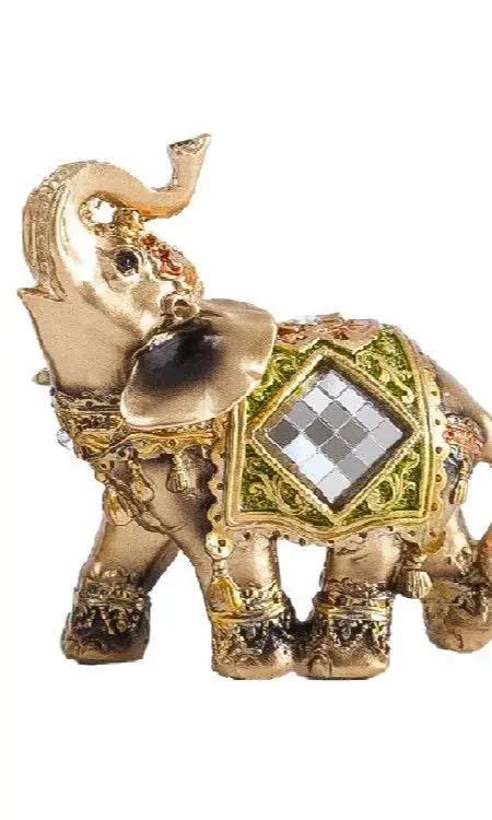 An Elephant Figurine Is Decorated With Gold And Jewels