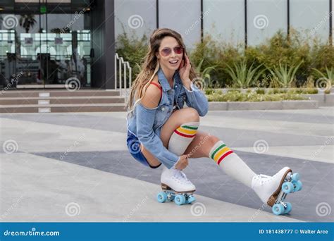 Lovely Brunette Female Model Rollerskates At The Beach Stock Image