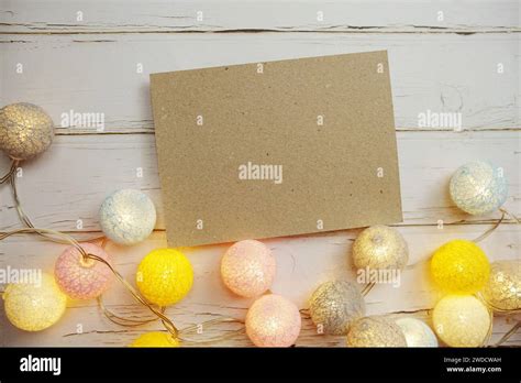 Empty Paper Caft With Led Cotton Balls On Wooden Background Stock Photo