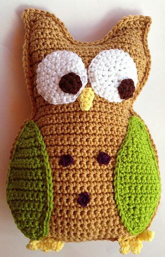 A Crocheted Owl Pillow Sitting On Top Of A Table