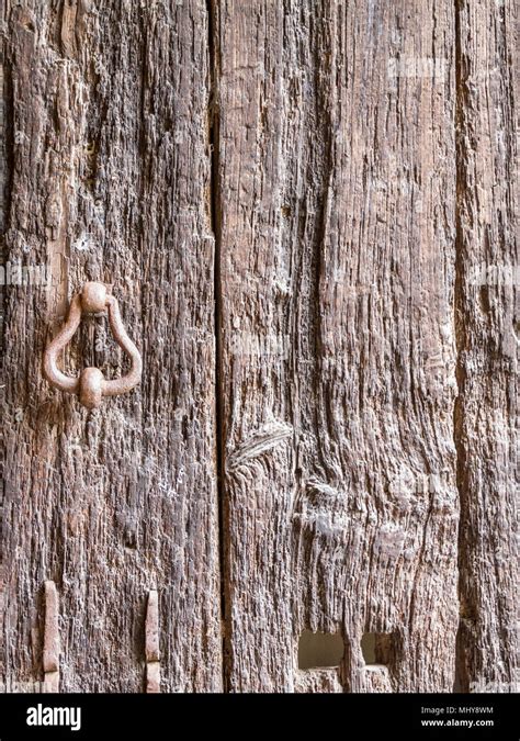 Detail Of Ancient Wooden Door With Rusty Iron Handle And Copy Space For