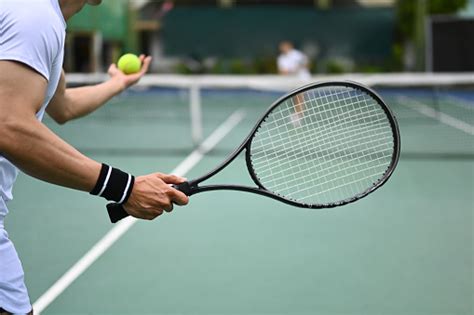 Tennis Player Serving Tennis Ball During A Match On Open Court Sport ...