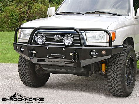 The Front End Of A White Truck Parked On Top Of A Parking Lot With