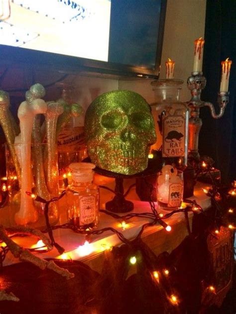 A Table Topped With Lots Of Bottles And Candles Next To A Flat Screen