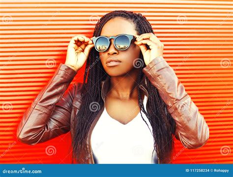 Stylish Young African Woman Wearing A Jacket Sunglasses In City Stock