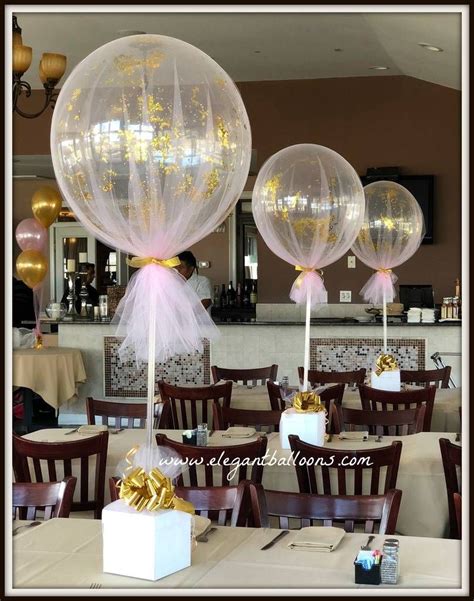 some balloons that are sitting on top of tables