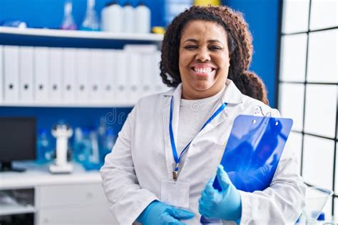 African American Woman Scientist Smiling Confident Holding Clipboard At