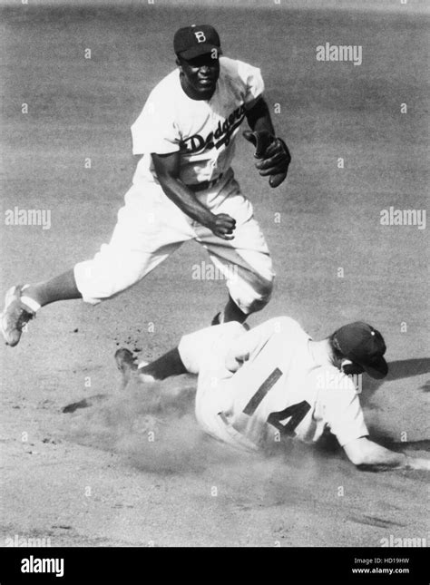 Brooklyn Dodgers Second Baseman Jackie Robinson Making The Turn On A