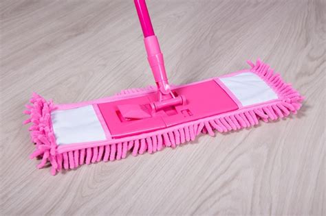 premium photo cleaning concept wooden floor  pink mop
