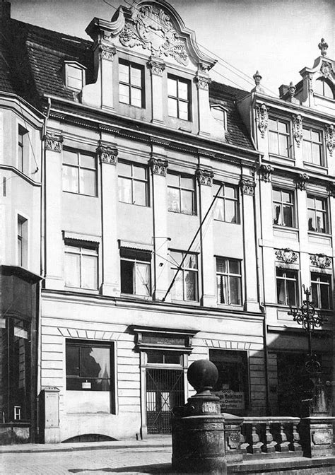 Black And White Photograph Of An Old Building On The Corner Of A Street