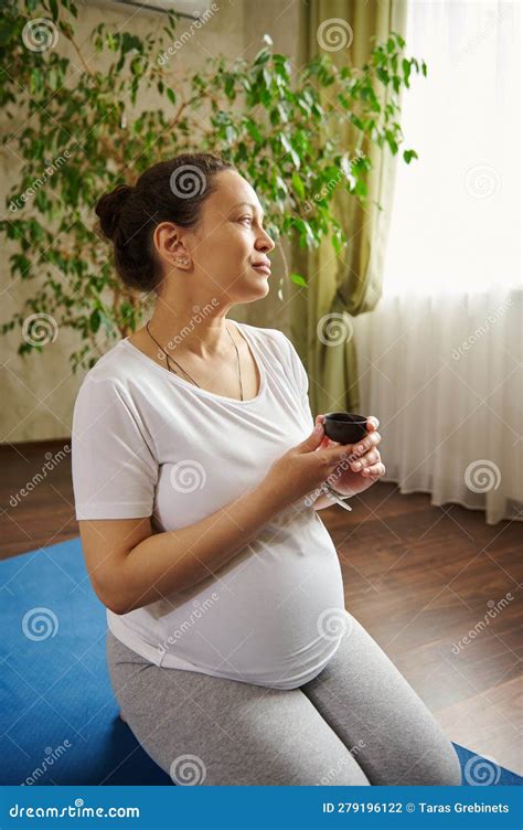 Delightful Multi Ethnic Pregnant Woman Drinking Tea Relaxing After