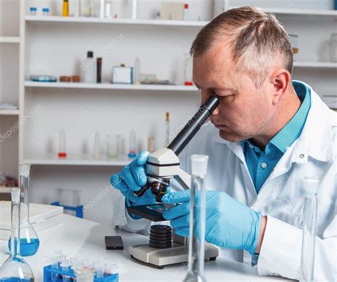 Male Scientific Researcher Using Microscope In The Laboratory Stock