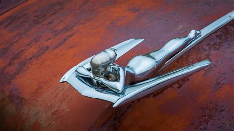 Nash Metropolitan Flying Lady Hood Ornament On A Rusty Red Hood