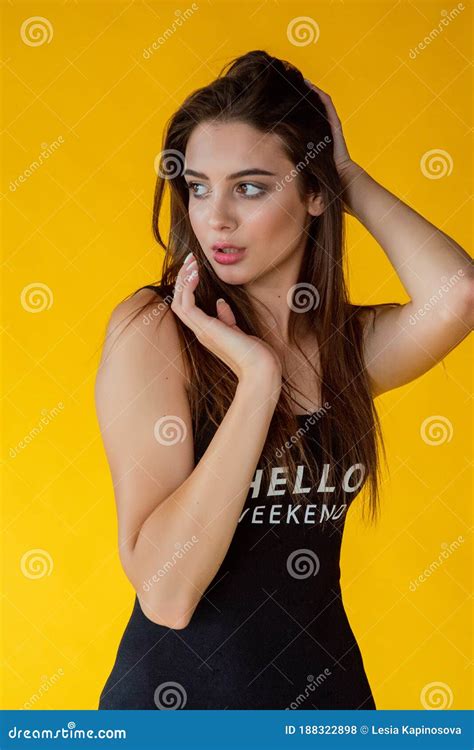 Girl On A Yellow Background Portrait Of A Beautiful Brunette Girl On A